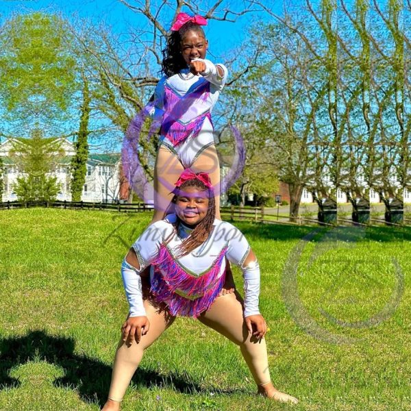 Stylish red and white majorette uniform with sequin details and pleated skirt.