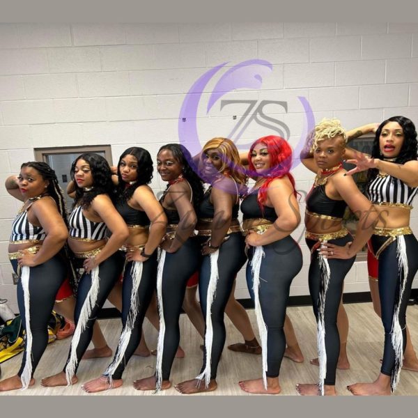 Stylish red and white majorette uniform with sequin details and pleated skirt.