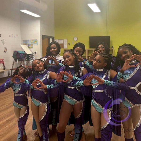 Stylish red and white majorette uniform with sequin details and pleated skirt.