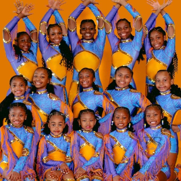 Stylish red and white majorette uniform with sequin details and pleated skirt.